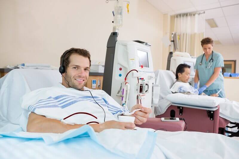 Kidney Patient on ward, Holding Cup of Crushed Ice During Renal Dialysis
